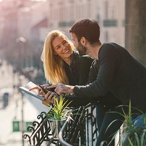 Moratoria Legal - Pareja joven en una terraza consultando datos en tablet